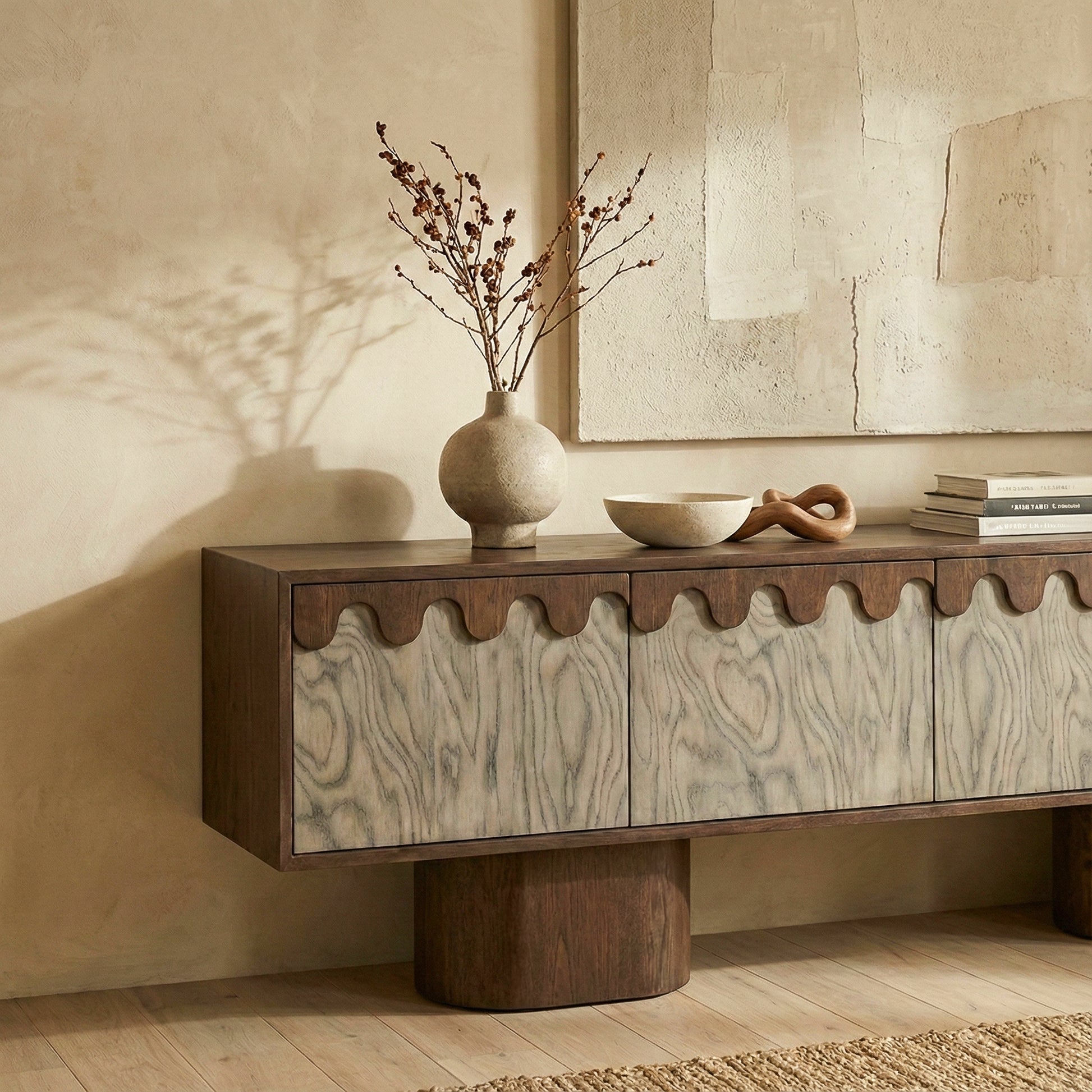 Wooden console table with decorative items against a beige wall